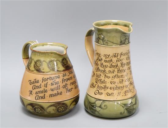 Two Doulton Art Nouveau motto jugs, c.1910, the tallest inscribed Come on my old friend and take a pot...... and the squat jug Take